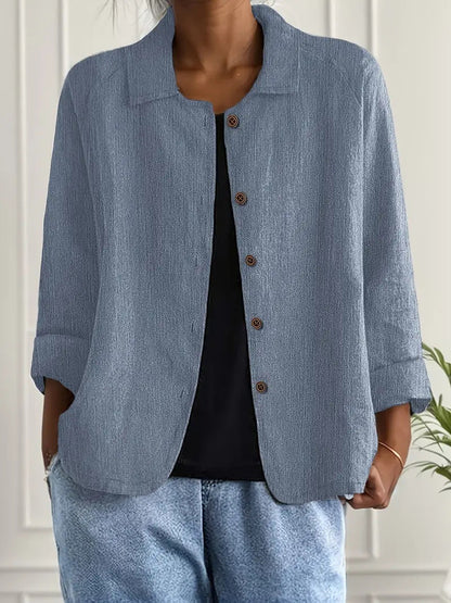 Person wearing a light blue jacket and pants with a white background