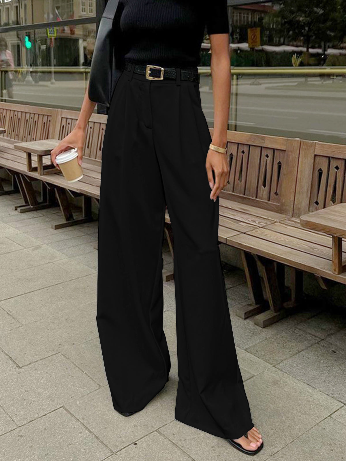 Woman wearing casual long pants for everyday outfits on a plain background.