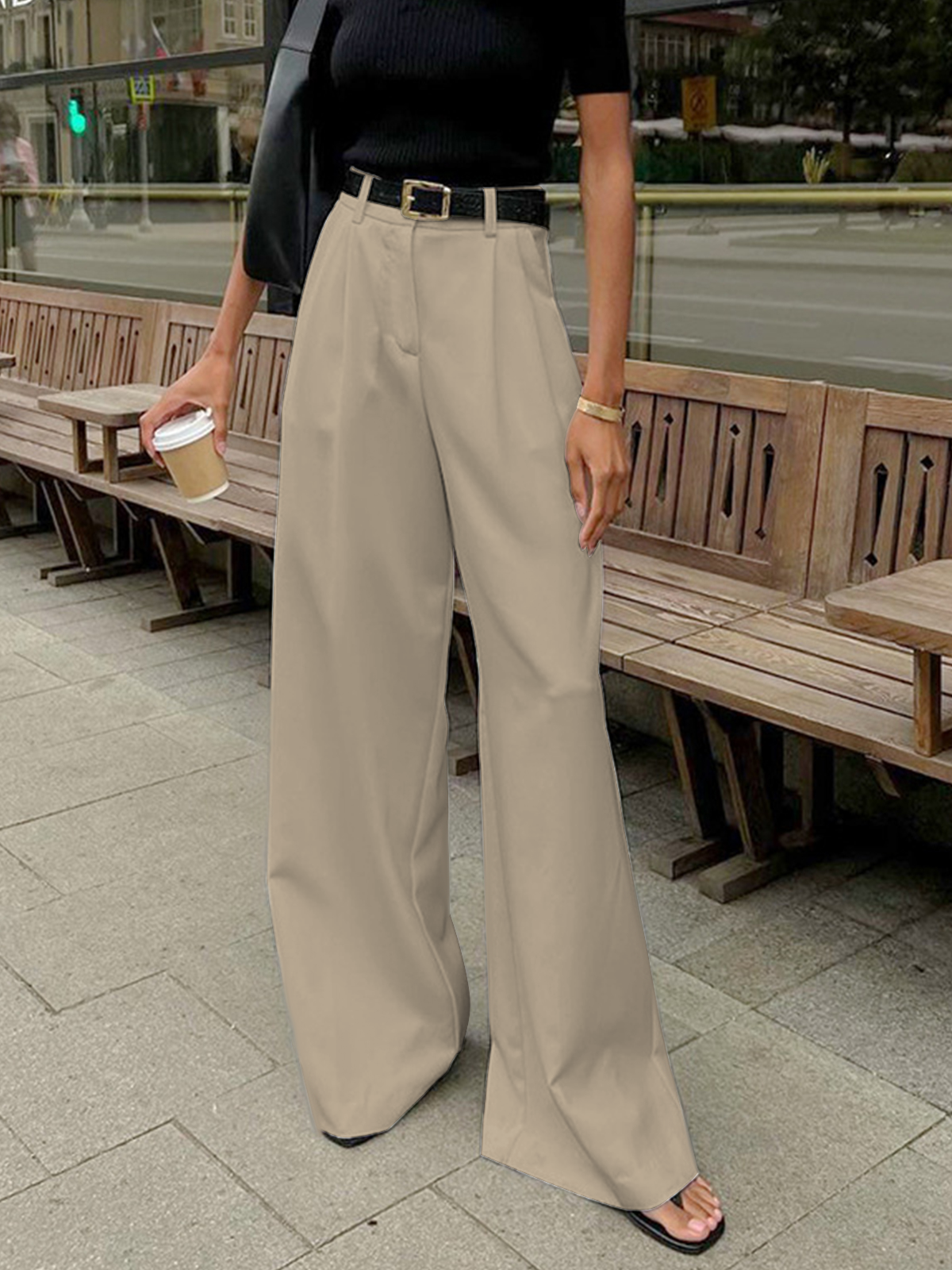 Female model showing front view of regular fit long pants on a plain background.