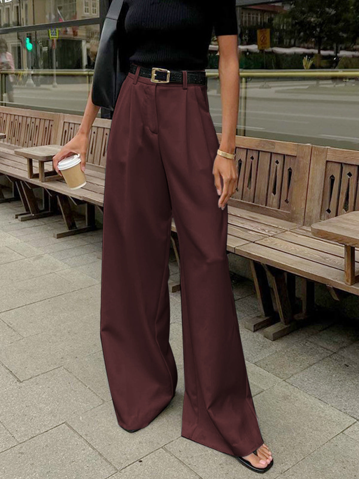Woman wearing long pants with a clean straight look on a plain background.