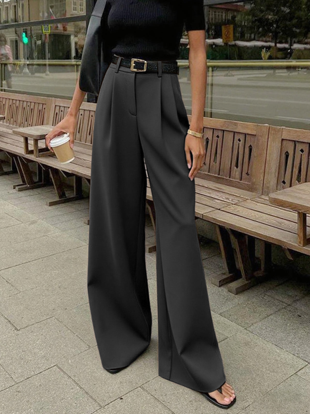 Female model wearing non-stretch long pants on a plain background.