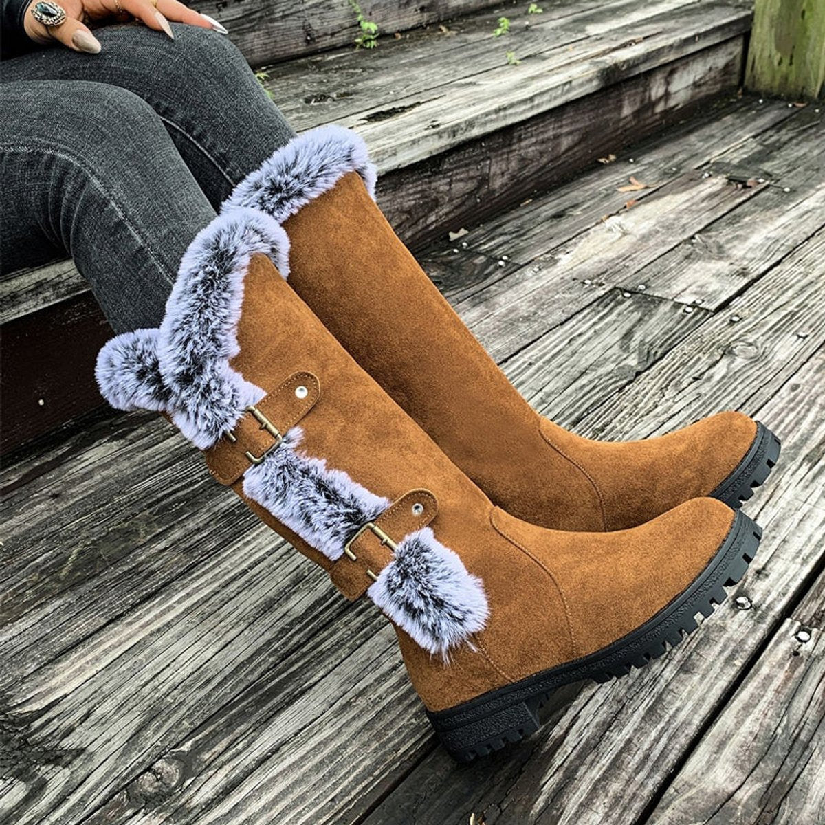 Black knee high boots featuring plush faux fur trim and adjustable buckle straps, perfect for women seeking stylish and warm long boots for cold weather. 1