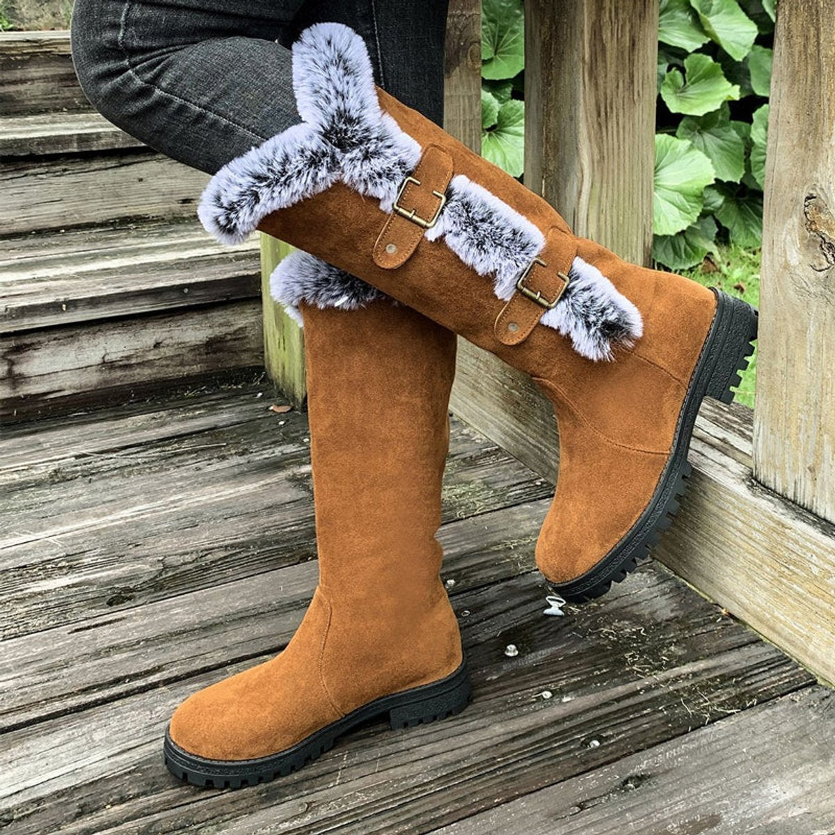 Black knee high boots featuring plush faux fur trim and adjustable buckle straps, perfect for women seeking stylish and warm long boots for cold weather. 4