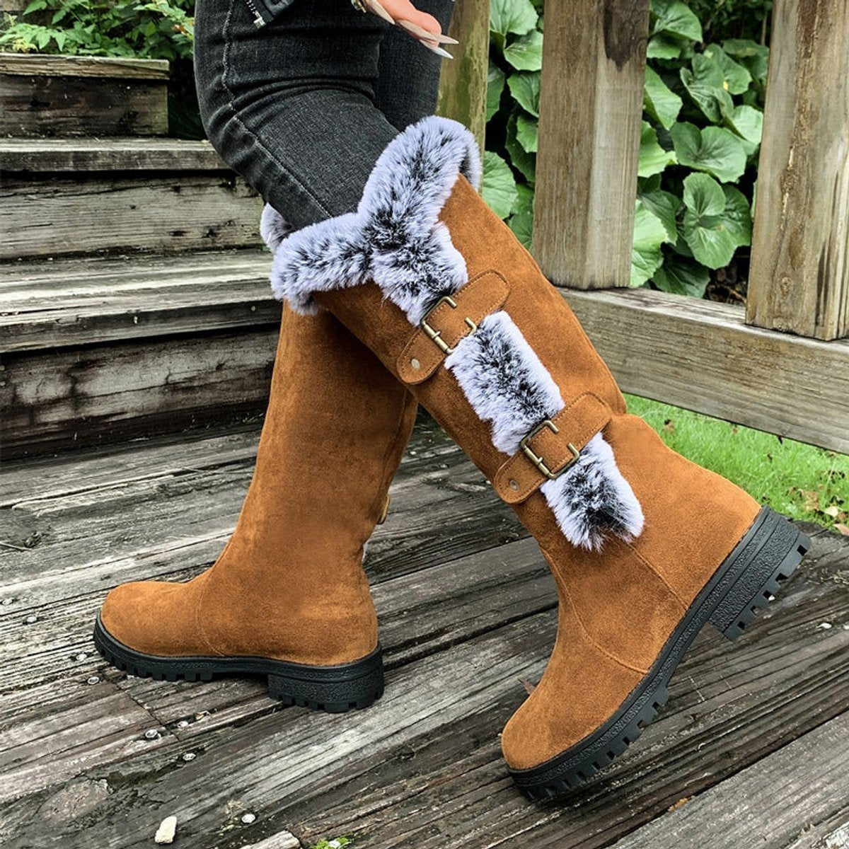 Black knee high boots featuring plush faux fur trim and adjustable buckle straps, perfect for women seeking stylish and warm long boots for cold weather. 5