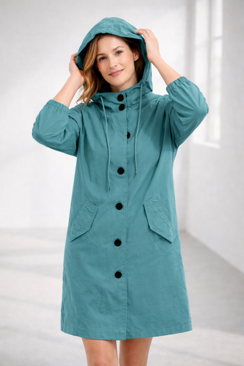 Turquoise hooded longline winter coat with patch pockets