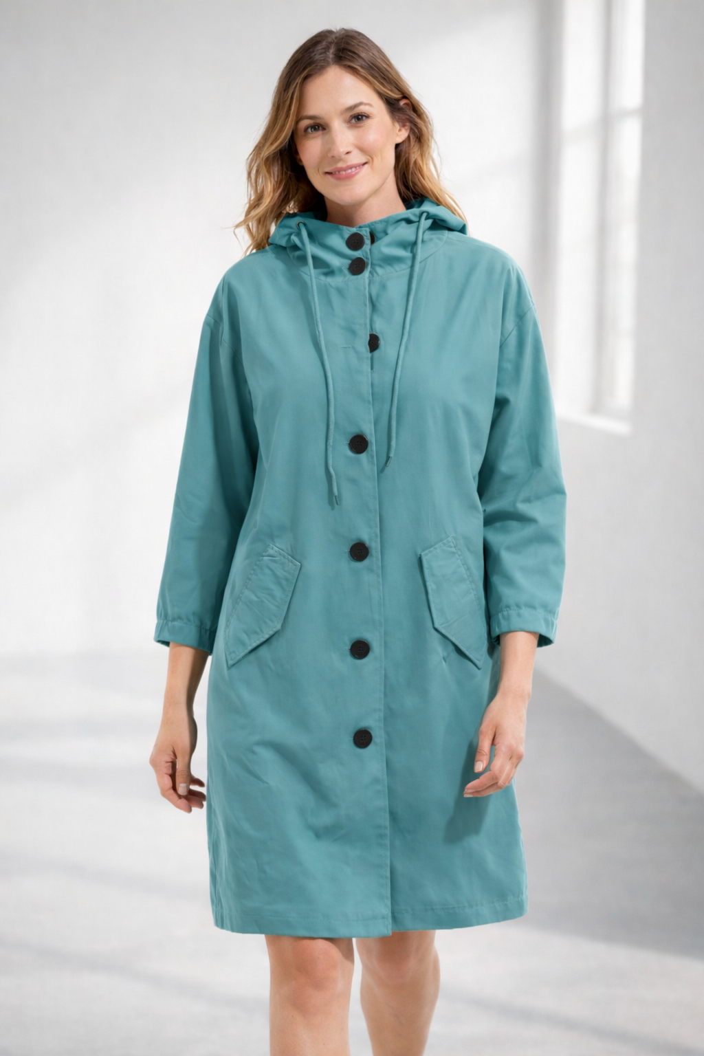 Turquoise hooded longline winter coat with patch pockets, front view