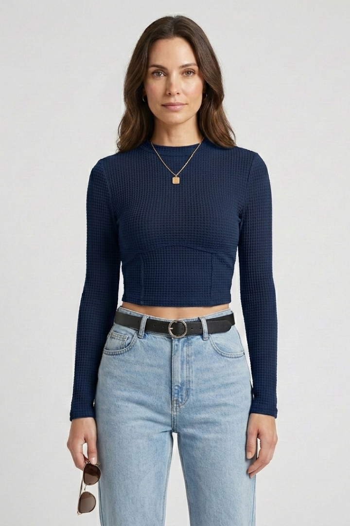 Woman in sleek cropped jersey top and in light blue jeans product image front